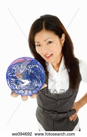 Beautiful Asian businesswoman with the world in the palm of her hand View Large Photo Image Stock Image - Beautiful Asian businesswoman with the world in the palm of her hand. Fotosearch