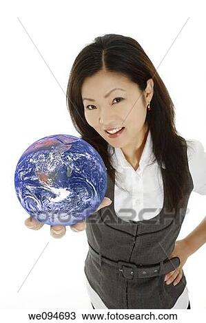 Beautiful Asian businesswoman with the world in the palm of her hand View Large Photo Image Stock Image - Beautiful Asian businesswoman with the world in the palm of her hand. Fotosearch