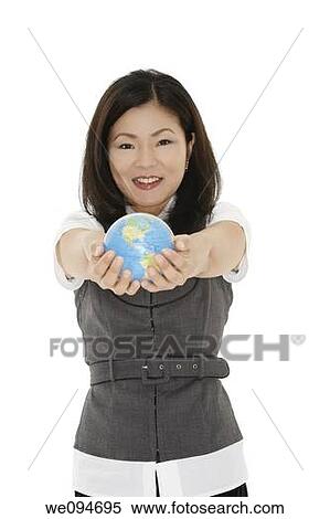 Beautiful Asian businesswoman with the world in the palm of her hand View Large Photo Image Stock Photography - Beautiful Asian businesswoman with the world in the palm of her hand. Fotosearch