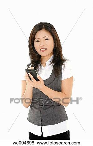 Beautiful Asian businesswoman working with a PDA on white background View Large Photo Image Stock Photo - Beautiful Asian businesswoman working with a PDA on white background. Fotosearch