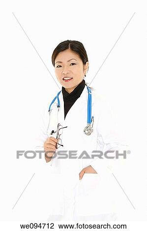 Stock Image - Beautiful Asian doctor or nurse on a white background. Fotosearch