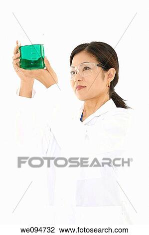 Beautiful Asian laboratory technician studying a beaker of liquid View Large Photo Image Stock Image - Beautiful Asian laboratory technician studying a beaker of liquid. Fotosearch