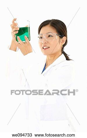 Beautiful Asian laboratory technician studying a beaker of liquid View Large Photo Image Stock Image - Beautiful Asian laboratory technician studying a beaker of liquid. Fotosearch