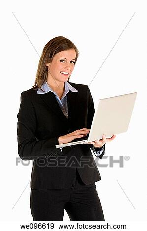 Beautiful Caucasian business holding a laptop computer View Large Photo Image Stock Photo - Beautiful Caucasian business holding a laptop computer. Fotosearch