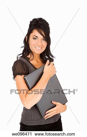 Stock Image - Beautiful Caucasian business woman holding a laptop computer while standing on white background. Fotosearch