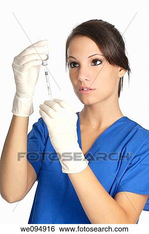 Beautiful Caucasian doctor / nurse with hypodermic syringe that is being filled with vaccine View Large Photo Image Stock Photograph - Beautiful Caucasian doctor / nurse with hypodermic syringe that is being filled with vaccine. Fotosearch
