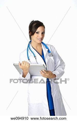 Beautiful Caucasian doctor or nurse holding a laptop computer View Large Photo Image Stock Image - Beautiful Caucasian doctor or nurse holding a laptop computer. Fotosearch