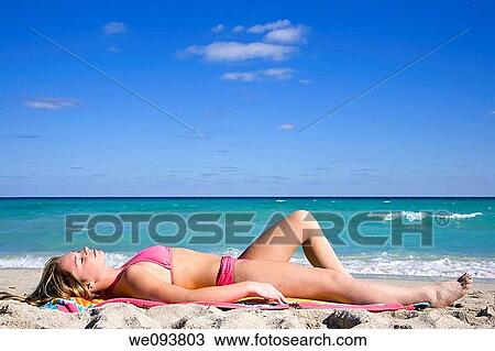 Beautiful Caucasian female teenage laying on the beach wearing a colorful bikini View Large Photo Image Stock Image - Beautiful Caucasian female teenage laying on the beach wearing a colorful bikini. Fotosearch