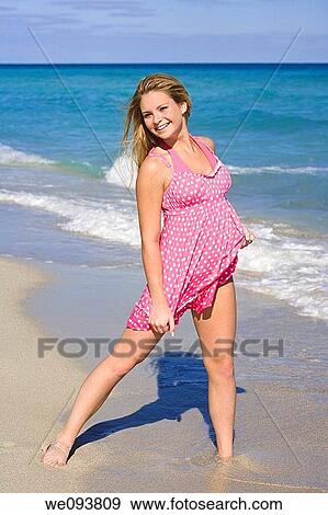 Beautiful Caucasian female teenage standing in the surf wearing a colorful sundress View Large Photo Image Stock Photo - Beautiful Caucasian female teenage standing in the surf wearing a colorful sundress. Fotosearch