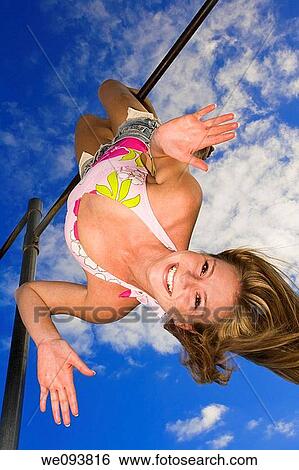 Beautiful Caucasian female teenage hanging upside down on outdoor gym bar and wearing a swimsuit View Large Photo Image Stock Photograph - Beautiful Caucasian female teenage hanging upside down on outdoor gym bar and wearing a swimsuit. Fotosearch