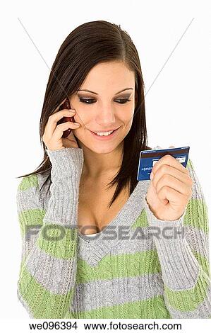 Beautiful Caucasian female using a credit card to make a purchase View Large Photo Image Picture - Beautiful Caucasian female using a credit card to make a purchase. Fotosearch