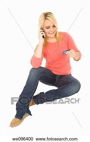 Beautiful Caucasian female using a credit card to make a purchase View Large Photo Image Stock Image - Beautiful Caucasian female using a credit card to make a purchase. Fotosearch