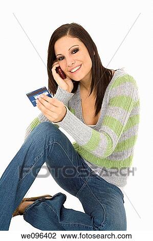 Beautiful Caucasian female using a credit card to make a purchase View Large Photo Image Stock Image - Beautiful Caucasian female using a credit card to make a purchase. Fotosearch