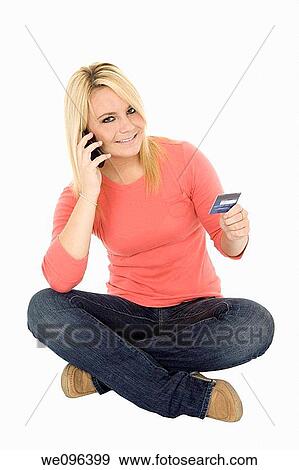 Beautiful Caucasian female using a credit card to make a purchase View Large Photo Image Stock Photo - Beautiful Caucasian female using a credit card to make a purchase. Fotosearch