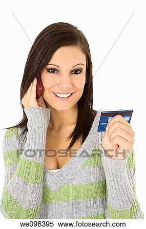 Beautiful Caucasian female using a credit card to make a purchase View Large Photo Image Stock Photography - Beautiful Caucasian female using a credit card to make a purchase. Fotosearch