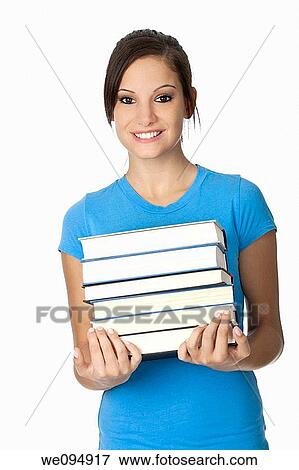 Stock Photo - Beautiful Caucasian student with a hand full of books. Fotosearch