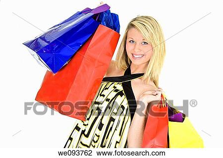 Beautiful Caucasian teen holding shopping bags while standing on a white background View Large Photo Image Stock Image - Beautiful Caucasian teen holding shopping bags while standing on a white background. Fotosearch