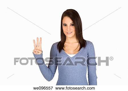 Stock Photo - Beautiful Caucasian teenager counting on fingers on green background. Fotosearch
