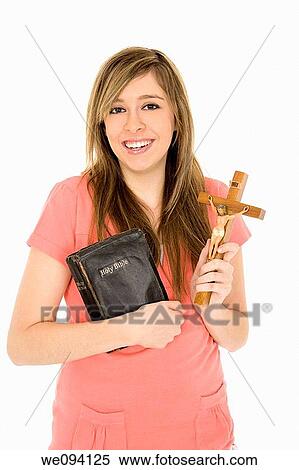 Beautiful caucasian teenager holding a bible and crucifix on a white background View Large Photo Image Stock Photography - Beautiful caucasian teenager holding a bible and crucifix on a white background. Fotosearch