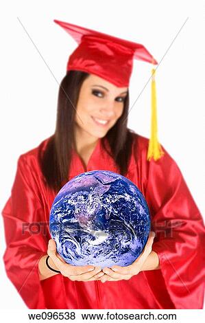 Beautiful Caucasian teenager in a graduation gown holding the world View Large Photo Image Stock Photo - Beautiful Caucasian teenager in a graduation gown holding the world. Fotosearch