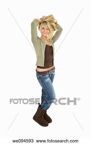 Stock Image - Beautiful caucasian teenager standing on white background smiling with some attitude. Fotosearch