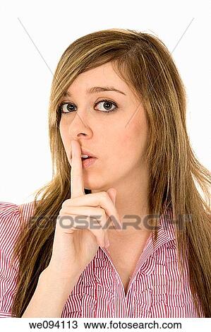 Beautiful Caucasian teenager using her finger to display the quiet gesture View Large Photo Image Stock Image - Beautiful Caucasian teenager using her finger to display the quiet gesture. Fotosearch