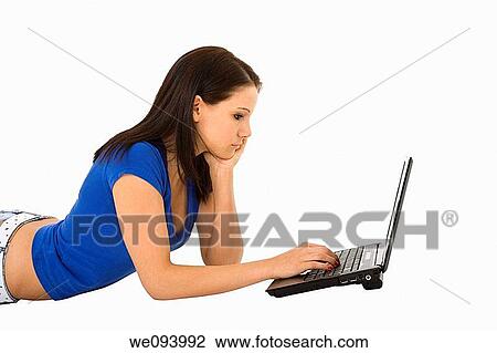 Beautiful caucasian woamn laying on a white background working on laptop computer View Large Photo Image Stock Image - Beautiful caucasian woamn laying on a white background working on laptop computer. Fotosearch