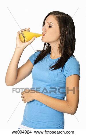 Beautiful Caucasian woman drinking a glass of orange juice View Large Photo Image Picture - Beautiful Caucasian woman drinking a glass of orange juice. Fotosearch