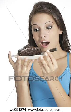 Beautiful Caucasian woman eating a slice of chocolate cake View Large Photo Image Picture - Beautiful Caucasian woman eating a slice of chocolate cake. Fotosearch