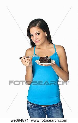 Beautiful Caucasian woman eating a slice of chocolate cake View Large Photo Image Stock Image - Beautiful Caucasian woman eating a slice of chocolate cake. Fotosearch