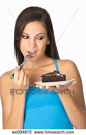 Beautiful Caucasian woman eating a slice of chocolate cake View Large Photo Image Stock Image - Beautiful Caucasian woman eating a slice of chocolate cake. Fotosearch