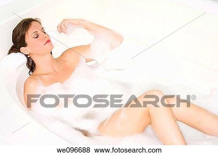 Stock Photo - Beautiful Caucasian woman enjoying a nice bubble bath. Fotosearch