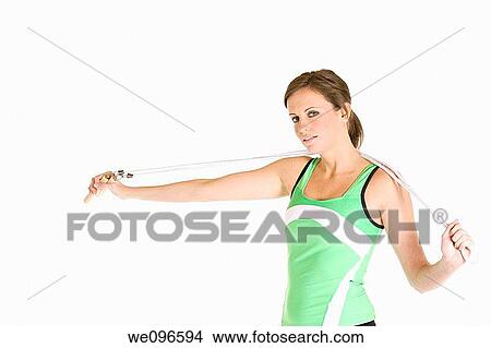 Beautiful Caucasian woman holding a jump rope in fitness clothes View Large Photo Image Picture - Beautiful Caucasian woman holding a jump rope in fitness clothes. Fotosearch