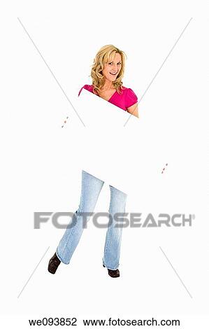 Beautiful Caucasian woman holding a blank sign so you can add your own advertising slogan She is on a white background View Large Photo Image Stock Image - Beautiful Caucasian woman holding a blank sign so you can add your own advertising slogan She is on a white background. Fotosearch