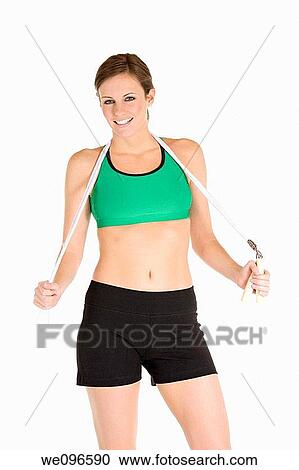 Beautiful Caucasian woman holding a jump rope in fitness clothes View Large Photo Image Stock Image - Beautiful Caucasian woman holding a jump rope in fitness clothes. Fotosearch