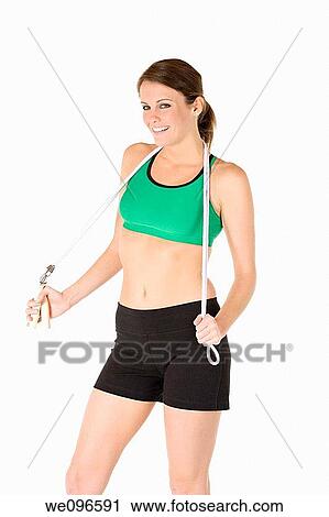 Beautiful Caucasian woman holding a jump rope in fitness clothes View Large Photo Image Stock Image - Beautiful Caucasian woman holding a jump rope in fitness clothes. Fotosearch