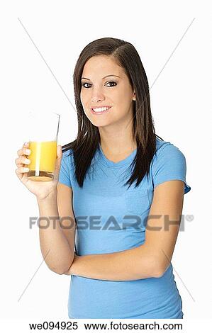 Beautiful Caucasian woman holding a glass of orange juice View Large Photo Image Stock Photography - Beautiful Caucasian woman holding a glass of orange juice. Fotosearch