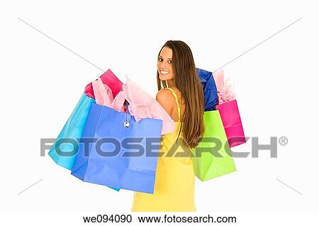 Beautiful Caucasian woman holding shopping bags while standing on a white background View Large Photo Image Stock Image - Beautiful Caucasian woman holding shopping bags while standing on a white background. Fotosearch