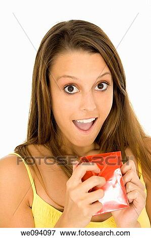 Beautiful Caucasian woman holding shopping bags while standing on a white background View Large Photo Image Stock Photo - Beautiful Caucasian woman holding shopping bags while standing on a white background. Fotosearch