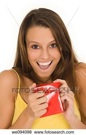 Beautiful Caucasian woman holding shopping bags while standing on a white background View Large Photo Image Stock Photo - Beautiful Caucasian woman holding shopping bags while standing on a white background. Fotosearch
