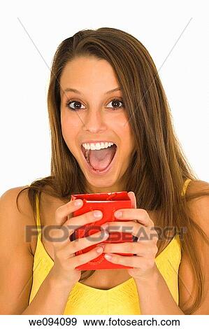 Beautiful Caucasian woman holding shopping bag while standing on a white background View Large Photo Image Stock Photo - Beautiful Caucasian woman holding shopping bag while standing on a white background. Fotosearch