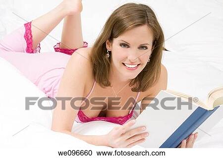 Beautiful Caucasian woman in bed reading a book View Large Photo Image Stock Image - Beautiful Caucasian woman in bed reading a book. Fotosearch