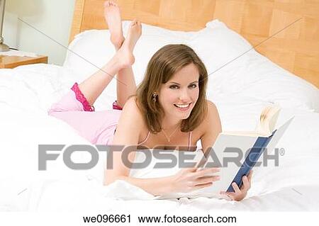 Beautiful Caucasian woman in bed reading a book View Large Photo Image Stock Image - Beautiful Caucasian woman in bed reading a book. Fotosearch
