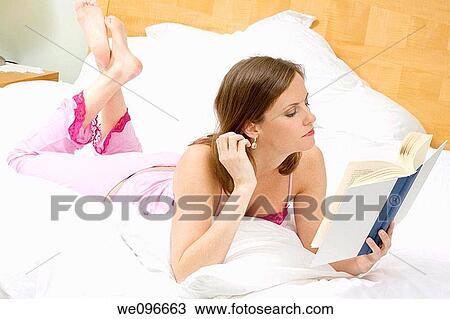 Beautiful Caucasian woman in bed reading a book View Large Photo Image Stock Image - Beautiful Caucasian woman in bed reading a book. Fotosearch