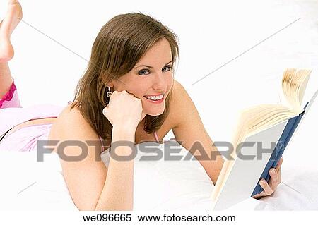 Beautiful Caucasian woman in bed reading a book View Large Photo Image Stock Photography - Beautiful Caucasian woman in bed reading a book. Fotosearch