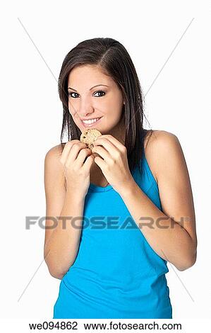 Beautiful Caucasian woman in her early 20s eating Chocolate Chip Cookies Concept of eating junk food View Large Photo Image Stock Image - Beautiful Caucasian woman in her early 20s eating Chocolate Chip Cookies Concept of eating junk food. Fotosearch