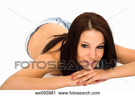 Stock Image - Beautiful caucasian woman laying on a white background wearing casaul clothing and smiling. Fotosearch