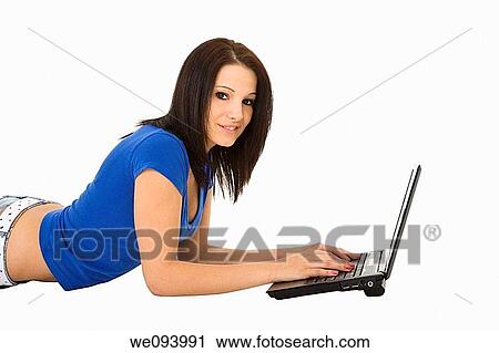 Beautiful caucasian woman laying on a white background working on laptop computer View Large Photo Image Stock Image - Beautiful caucasian woman laying on a white background working on laptop computer. Fotosearch