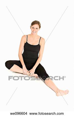 Beautiful Caucasian woman practicing Yoda on a white background View Large Photo Image Picture - Beautiful Caucasian woman practicing Yoda on a white background. Fotosearch