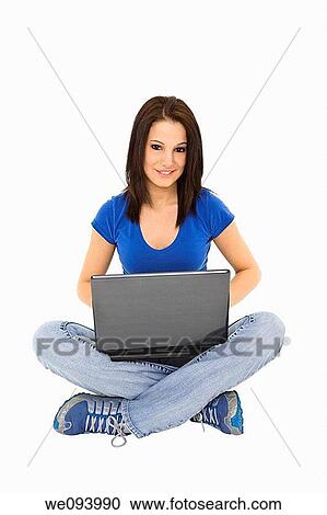 Beautiful caucasian woman sitting on a white background working on laptop computer View Large Photo Image Stock Image - Beautiful caucasian woman sitting on a white background working on laptop computer. Fotosearch